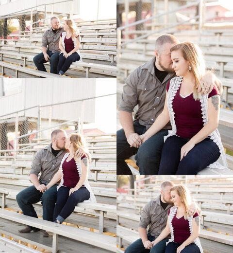 Couple posing on race track for engagement session photoshoot with dog